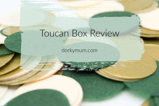 Text 'Toucan box review' on top of an image of green felt coaster