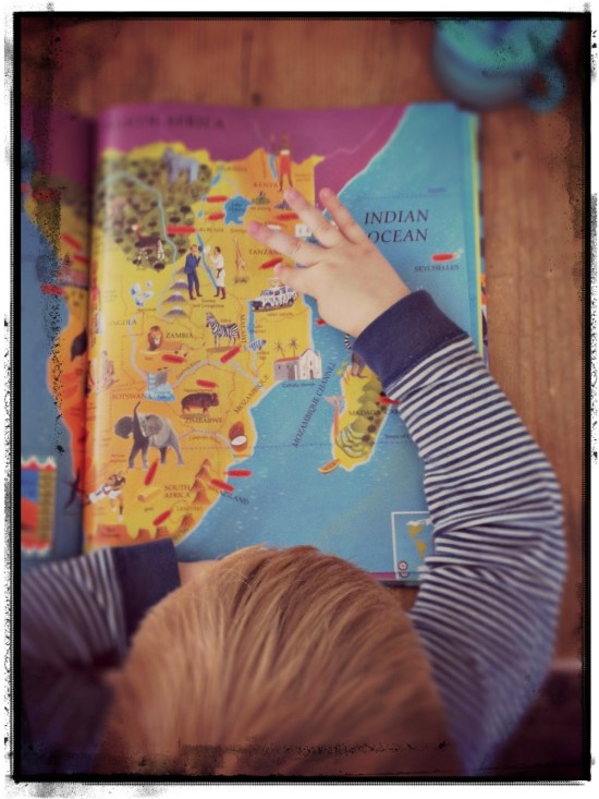 child looking at maps Barefoot Books atlas