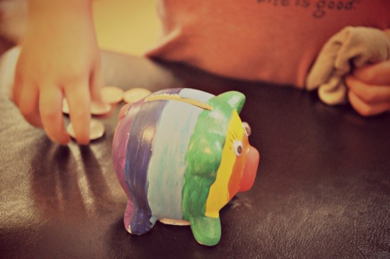 counting coins rainbow coloured Piggy Bank and coins