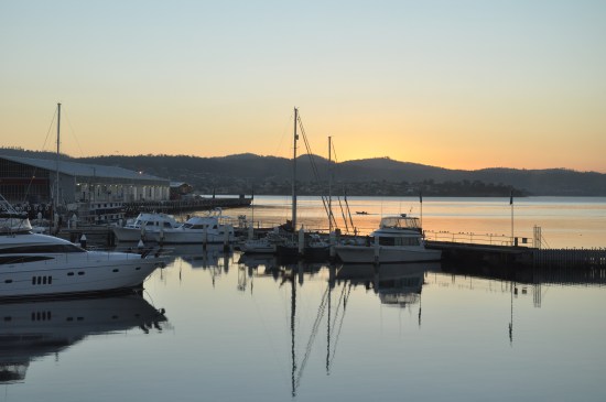 The sun setting over boats on the waterfront in Hobart, Tasmania