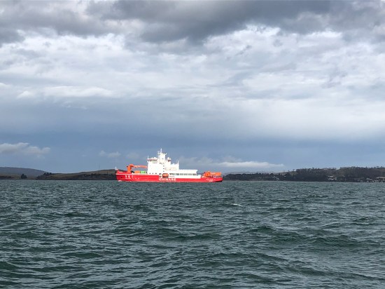 Chinese icebreaker research vessel Xue Long on the River Derwent in Tasmania, viewed from the wooden ship SV Rhona H