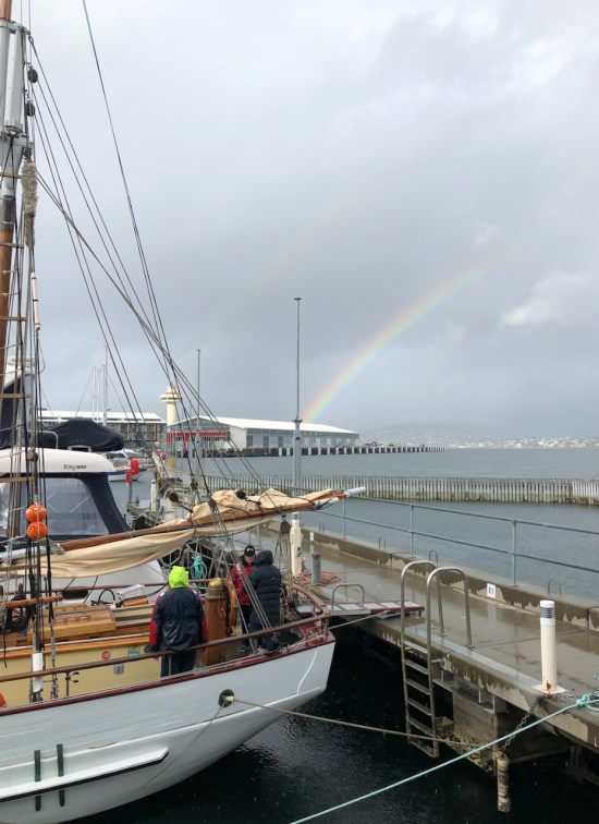 Rainbow at Hobart waterfront, old wooden ship SV Rhona H in foreground