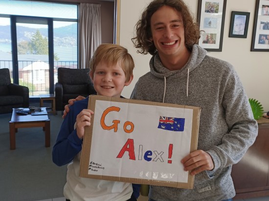 Tasmanian F3 Driver Alex Peroni standing with a young fan