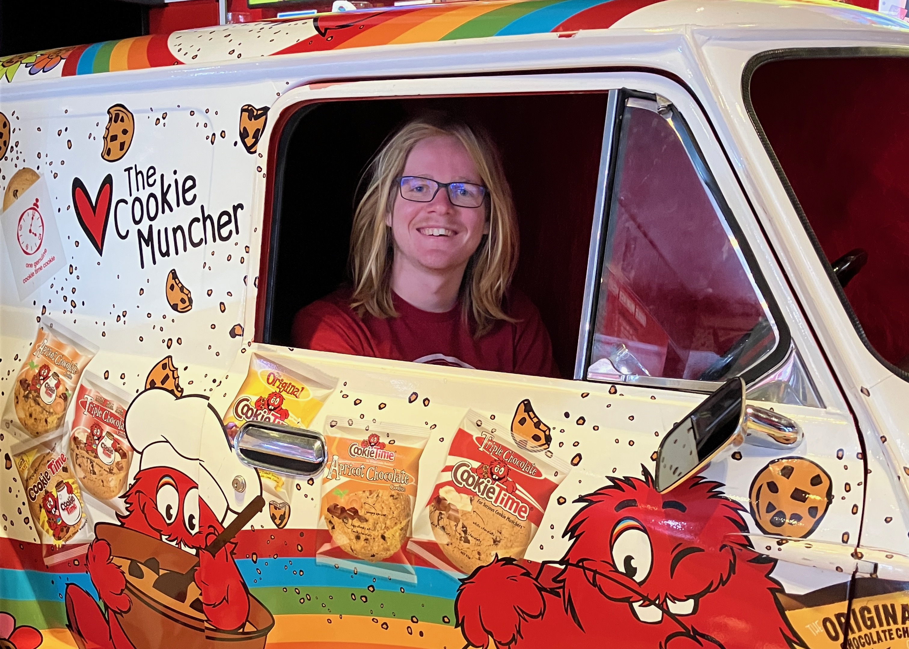 A teenage boy sits in the Cookie Time car at the Cookie Time Bar in Queenstown New Zealand