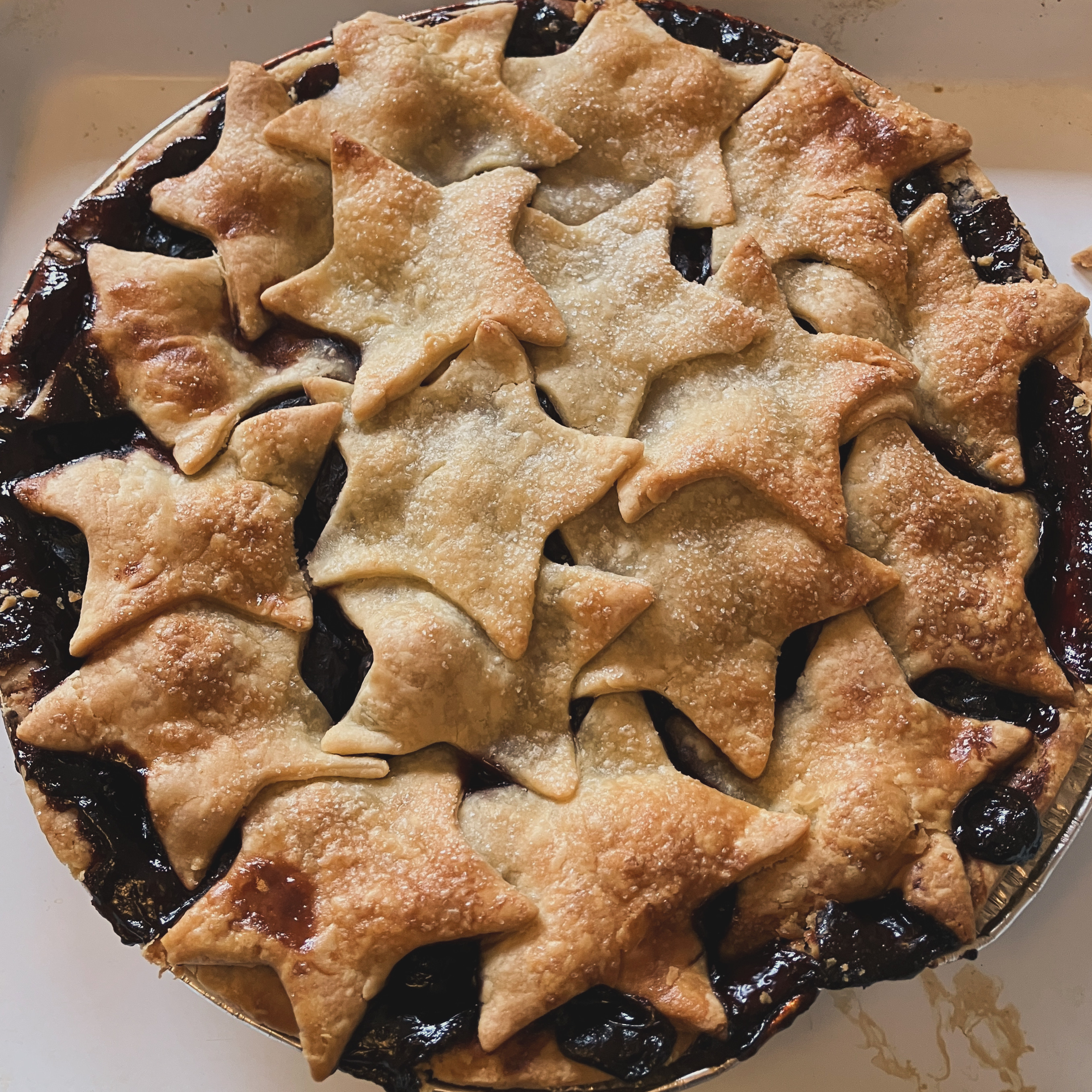 An image of a cherry piece with pastry on top shaped like stars