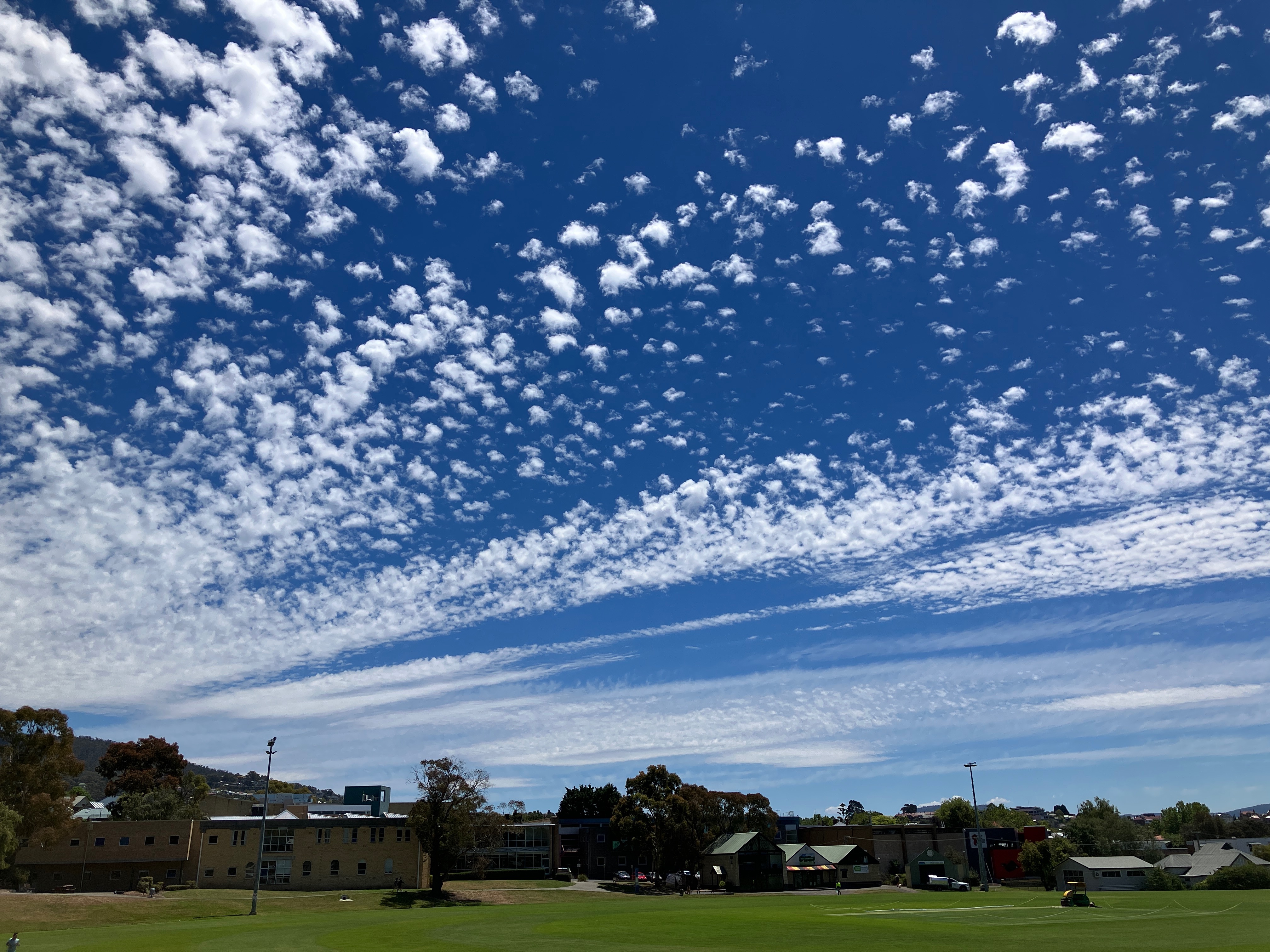 A blue sky on a sunny day with lots of pretty white clouds