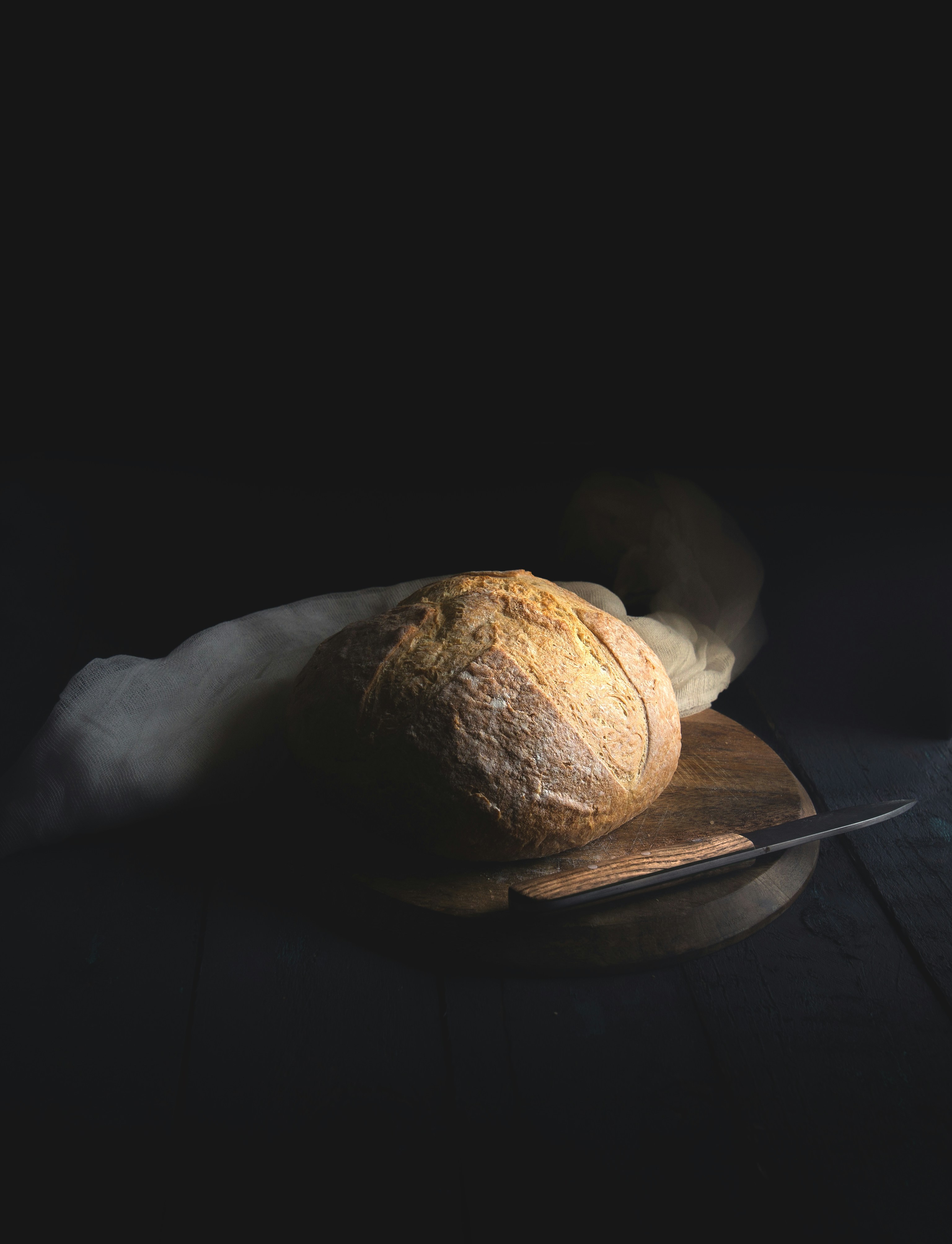 A loaf of bread on a wooden cutting board
